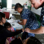 Kamila, daughter of Yenymar Vilches, Venezuelan migrant, is attended by personnel of the ship of the United States Navy Hospital USNS Comfort at Divina Pastora High School in Riohacha