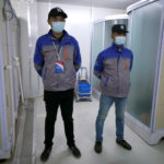 Security personnel wearing face masks stand guard near closed shower rooms inside the Leishenshan Hospital, a makeshift hospital for treating patients with the coronavirus disease (COVID-19), in Wuhan, Hubei